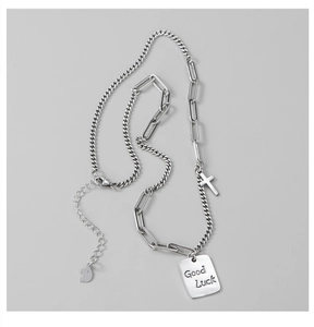 Detail of S925 sterling silver Luck square tag and cross pendant on mixed chain