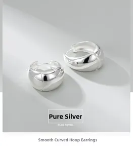 Detailed close-up of chunky S925 sterling silver hoop earrings with polished finish