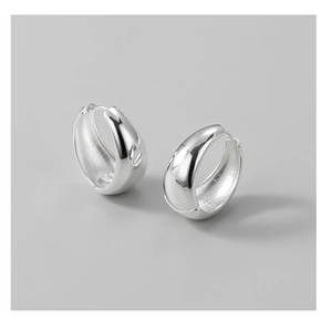 Close-up of chunky S925 sterling silver hoop earrings with a polished teardrop shape