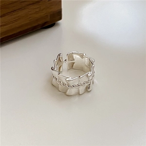 Detail of S925 sterling silver ring featuring pleated textures and braided rope design