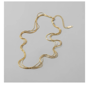 Macro shot of layered gold S925 silver necklaces with lobster clasp and adjustable chain