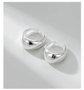 Macro shot of silver S925 sterling silver hoop earrings with high polish mirror finish