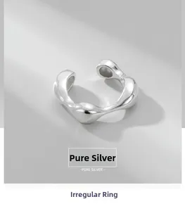 Macro view of minimalist S925 sterling silver ring with irregular fluid design