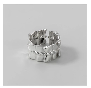 Macro view of S925 sterling silver pleated texture and twisted rope ring details