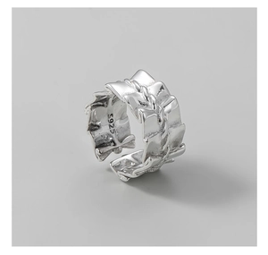 Detailed macro view of S925 sterling silver ring featuring pleated texture and chain detail