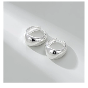 Detailed view of polished S925 sterling silver chunky hoop earrings with mirror finish