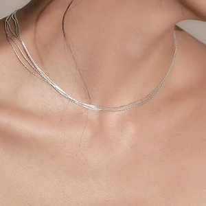 Elegant multi-layered S925 sterling silver chain necklace on female model neck