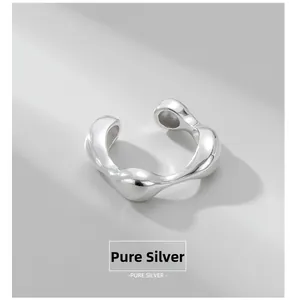 Macro shot of liquid-style sterling silver ear cuff with smooth streamlined metal design