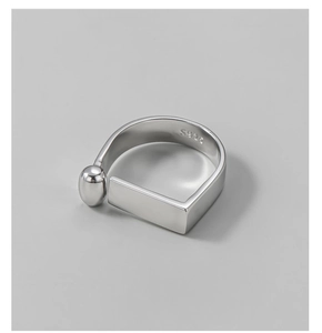 Detailed macro view of S925 silver ring featuring geometric rectangle and small bead design