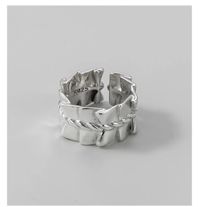 Macro detail of S925 sterling silver ring featuring pleated texture and braided rope design