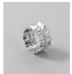 Macro detail of the S925 sterling silver stamp on a wide textured vintage ring band