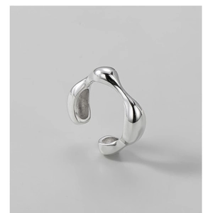 Detailed macro view of S925 sterling silver stamp on minimalist irregular fluid ring