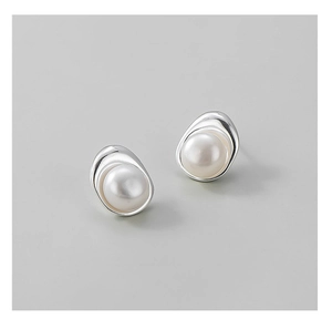 Close-up of S925 silver irregular organic base with glossy white pearl earrings