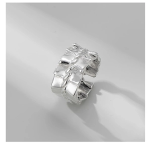 Detailed macro view of silver S925 sterling silver open ring with pleated armor texture
