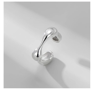 Macro shot of liquid metal style S925 sterling silver ring with irregular fluid lines