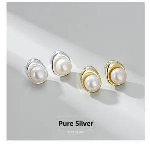Detail view of gold and silver S925 sterling silver earrings with glossy baroque pearls