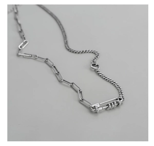 Macro detail of S925 silver paperclip link chain with creative pin connector design