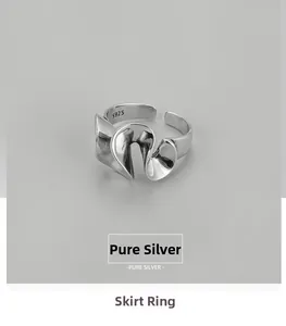 Detail view of wavy skirt texture and S925 hallmark on the silver adjustable ring