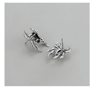 Detailed macro shot of vintage S925 silver spider earrings with black zircon stones