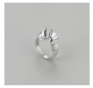Macro detail of S925 sterling silver ring showing abstract curves and S925 hallmark