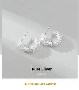 Detailed macro shot of S925 sterling silver hoop earrings with sparkling zircon stones