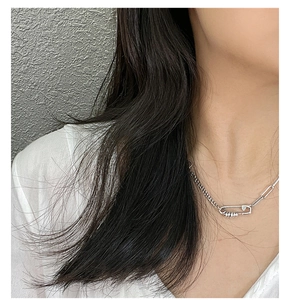 Detail of S925 sterling silver safety pin necklace with unique textured link chain