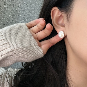 Minimalist S925 sterling silver earring with white pearl on a textured irregular base