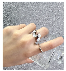 Close-up of vintage S925 sterling silver wavy and minimalist open rings on model's fingers