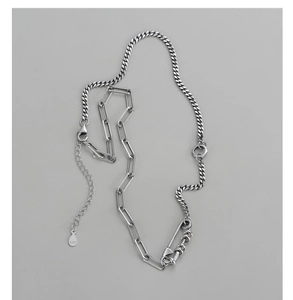 Macro detail of S925 sterling silver paperclip and cuban link chain necklace
