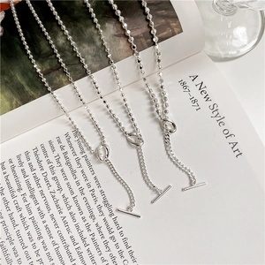 S925 sterling silver bead chain necklace with OT toggle clasp on an art book display