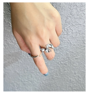 Detail of S925 sterling silver stacked rings with irregular pleat and minimalist design