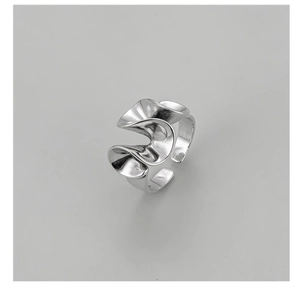 Macro detail of abstract wavy S925 sterling silver ring with polished artistic texture