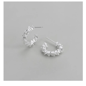 Detail of S925 sterling silver hoop earrings with irregular crushed silver texture surface