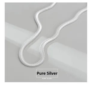 Macro shot of polished S925 sterling silver flat snake chain necklace with sleek texture