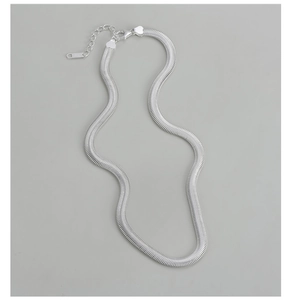 Detailed macro view of S925 sterling silver flat snake chain with lobster clasp and stamp