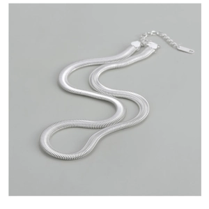 Detail of S925 sterling silver flat snake chain with lobster clasp and extension link
