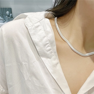 Polished S925 sterling silver flat snake bone chain necklace worn on a woman's neck
