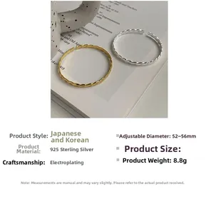 Detail of twisted S925 sterling silver bracelets in gold and silver finish with adjustable size