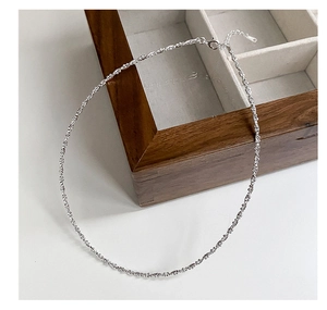 Detail of 925 sterling silver choker necklace with shimmering textured chain and lobster clasp