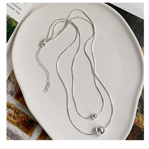 Close-up of S925 sterling silver double layer snake chain necklace with beads