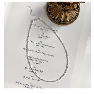 Detail of 925 sterling silver choker necklace with shimmering starry texture and extension chain