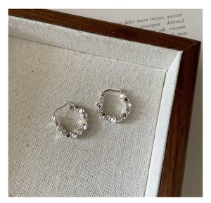 Macro shot of S925 sterling silver hoop earrings with unique geometric block texture