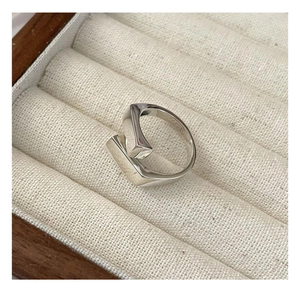 Macro view of geometric S925 sterling silver ring showing minimalist polished rectangle ends