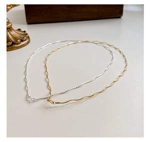 Detailed view of wave-textured S925 sterling silver necklaces in gold and silver finish