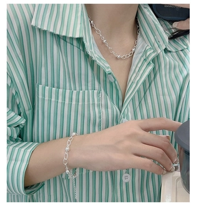 Minimalist 925 sterling silver beaded bracelet and necklace set shown on a female model
