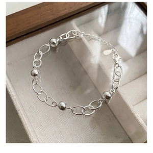 Close-up of 925 sterling silver beaded chain bracelet with lobster clasp and extension