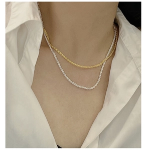 Detail of gold and silver S925 sterling silver rope twist necklaces for layering style