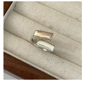 Macro shot of S925 sterling silver geometric ring with parallel square bars on velvet