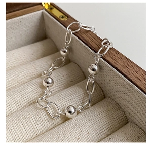 Detailed close-up of 925 sterling silver beaded bracelet on a premium jewelry box padding