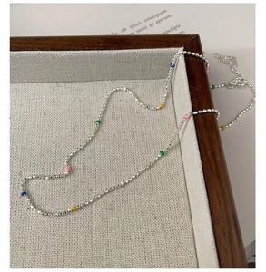 Detailed macro of S925 silver beaded necklace with colorful accent beads and lobster clasp